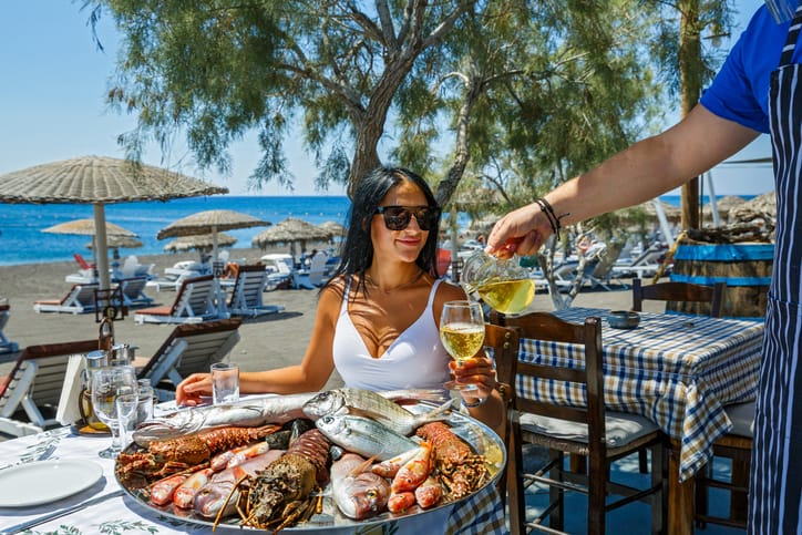 Lady eating greek seafood